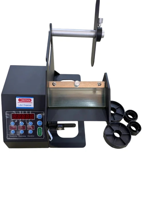 A black automatic label printer machine with a digital control panel, a metal printing bed, a spool holder, and several black circular rollers, shown on a plain white background. - Retsol X200 Label Dispenser | Automatic Barcode & Sticker Label Dispenser Machine | POSMEA India